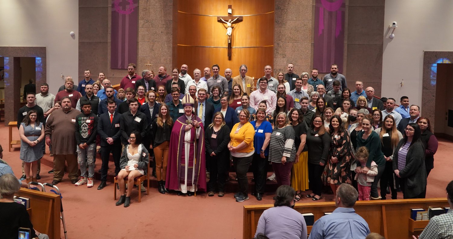 Candidates for the Sacraments of Confirmation and First Holy Communion gather with Bishop W. Shawn McKnight in the sanctuary of Our Lady of Lourdes Church in Columbia on March 6, the First Sunday of Advent, following the Rite of Election and Call to Continuing Conversion.